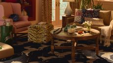 Eclectic, pattern-filled living room featuring a tiger print ottoman, wooden coffee table, and zebra motif area rug