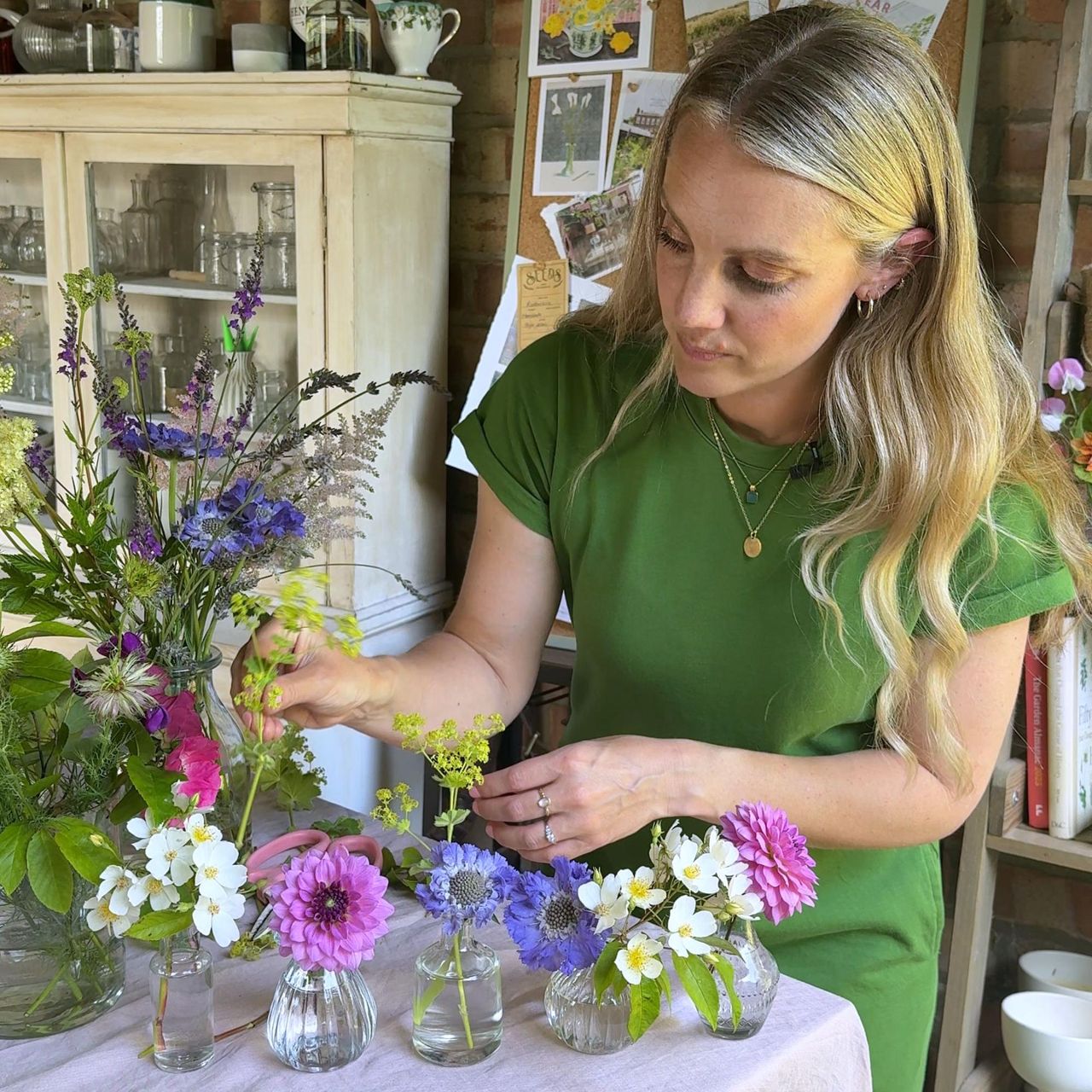Rachel Bull arranging wild flowers in bud vases