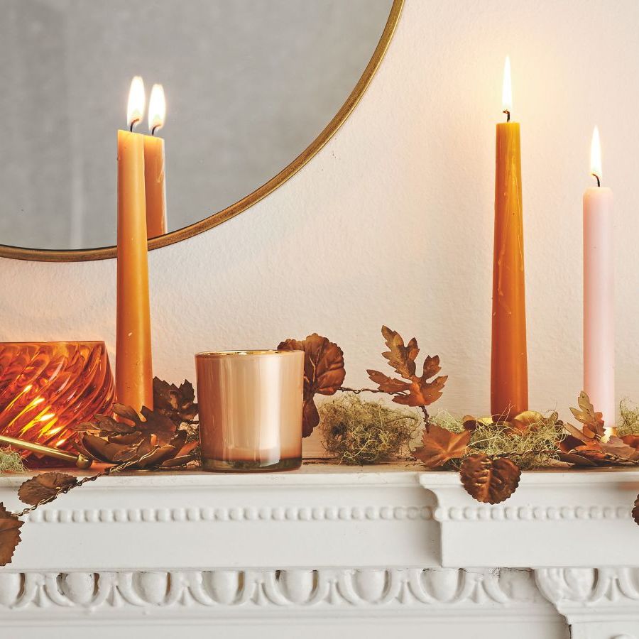 Mantel with candles and fall leaf decorations displayed